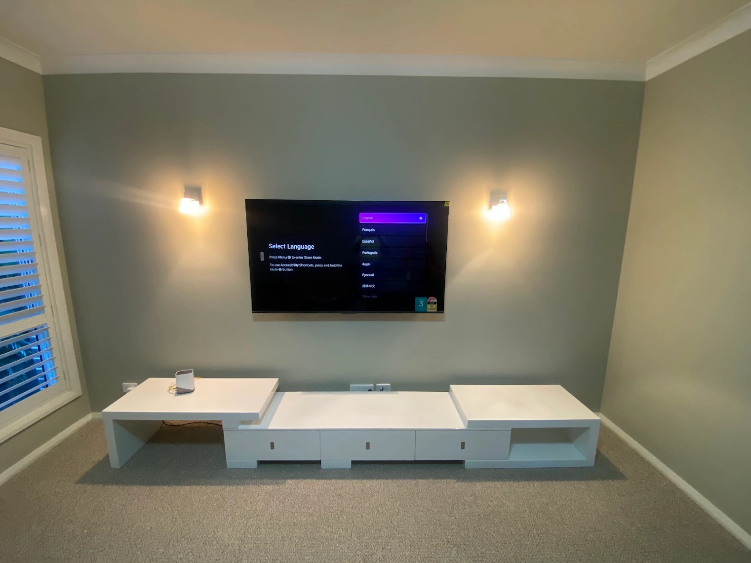 Living room TV mount with in-wall speaker installation
